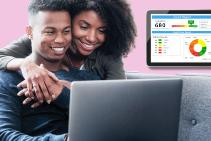 Attractive black couple smiling looking at a laptop screen. Credit report