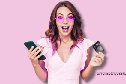 woman holding credit card and cell phone looking surprised