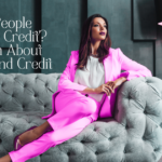 Wealthy woman sitting on a luxury couch in a pink suit, thinking about her bad credit. Wealth and credit